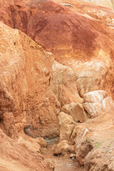 Red canyon in hills. Soil erosion following drought, climate change and formation of gullies. Lack of water in dry steppe
