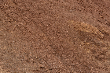 Red mountainside on hot day. Texture on wall of sandy canyon. Lack of water, drought from climate change