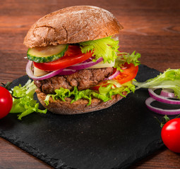 Tasty hamburger with rye bun