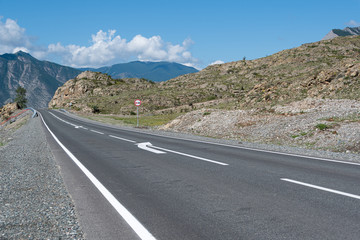 Asphalt road through hills and forest. Road trip in nature in mountains