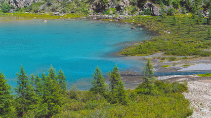 Blue lake in valley. Turquoise river in rocks. Hiking in mountains in Altai nature