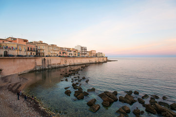Fototapeta na wymiar Cityscape of ancient buildings in seafront of Ortygia. Syracuse. Italy