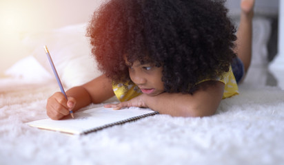 Cute little African student doing schoolwork