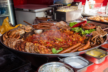 Novi Sad, Serbia - November 24, 2019: Different kinds of sausages, meat and grill on a Christmas Market in Novi Sad winter fest.