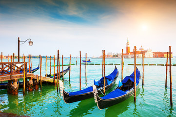 Fototapeta na wymiar Gondolas on the Grand Canal near San Marco square in Venice, Italy. Famous travel destination