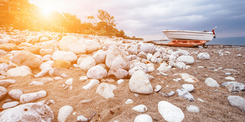 Old boat on beach near sea. Spa rocks on sand at ocean. Beautiful tropical morning landscape. Oriental calm, relax and harmony banner concept