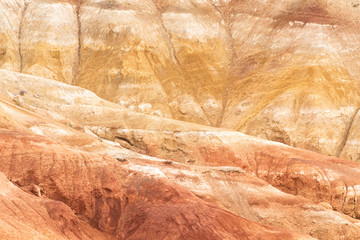 Rocks in canyon of dry river bed. Drought due to climate change. Soil erosion of hills. Red sand in mountains