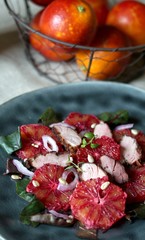 salad with red orange (blood orange), duck breast, beet top (chard), sunflower seeds, red onion. gourmet recipe, winter salad