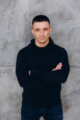 Fototapeta premium Photo session of a guy in a sweater on the eve of the new year.
