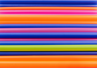 colored tubules for juice and cocktails on pink background. Colorful drink straws. straw, plastic free, reusable plastic drinking background, plastic free. Plastic pollution concept.