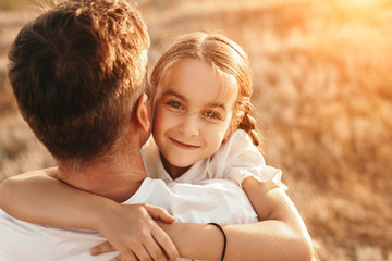 Daughter hugging father in nature