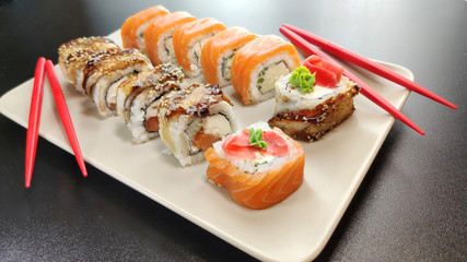 Japanese seafood sushi. Philadelphia and Canada sushi rolls on a plate.