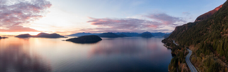 Fototapeta na wymiar Sea to Sky Hwy in Howe Sound near Horseshoe Bay, West Vancouver, British Columbia, Canada. Aerial panoramic view during a colorful sunset in Fall Season.