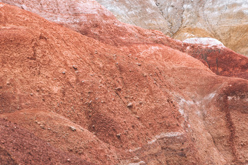 Rocks in canyon of dry river bed. Drought due to climate change. Soil erosion of hills. Red sand in mountains
