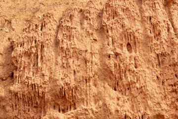 Red mountainside on hot day. Texture on wall of sandy canyon. Lack of water, drought from climate change