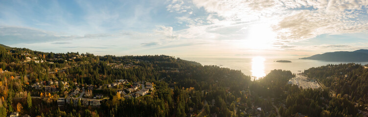 Horseshoe Bay, West Vancouver, British Columbia, Canada. Aerial view of residential homes near the Highway during a bright and sunny sunset in Fall Season.