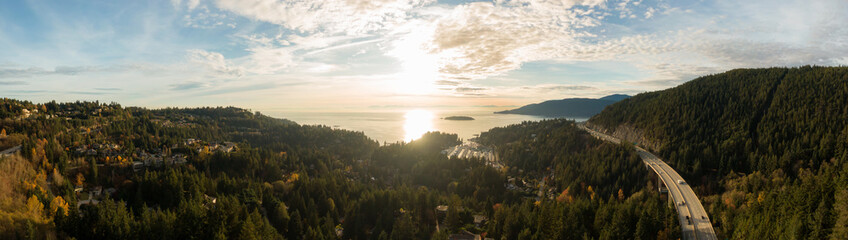 Horseshoe Bay, West Vancouver, British Columbia, Canada. Aerial view of residential homes near the Highway during a bright and sunny sunset in Fall Season.