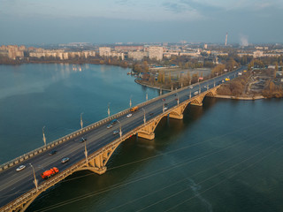 Fototapeta na wymiar Aerial autumn Voronezh cityscape from drone flight height. View of the Vogresovsky bridge over Voronezh Water Reservoir