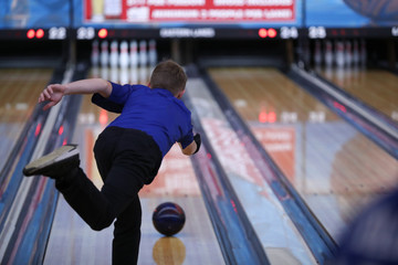 A high school student competes in a bowling match