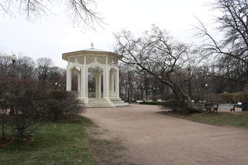 Vintage white stone gazebo in an empty Park in autumn.