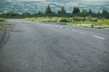 Empty highway road and green forest with clouds landscape. Panoramic city