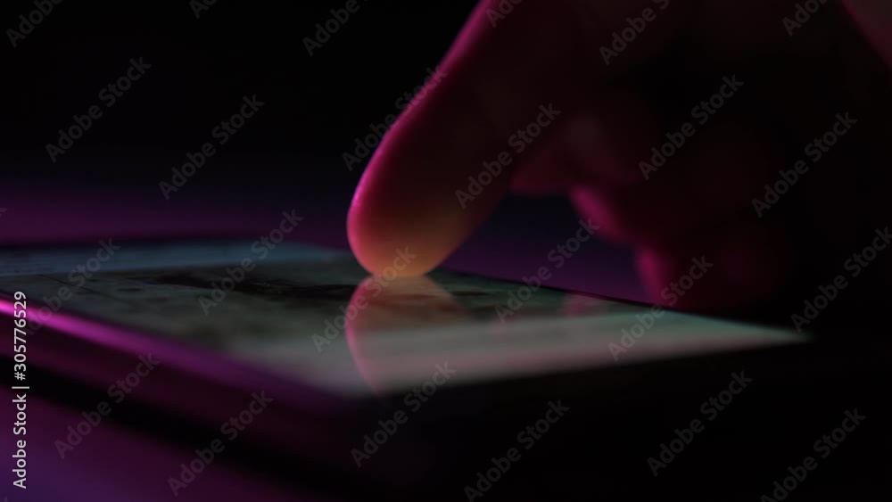 Wall mural man`s finger touching and scrolling a phone screen with instagram information