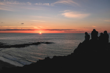 Family watch sunset