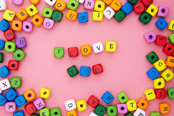 I LOVE you word, lettering on pink background. Valentine's Day, friendship, mother's Day. Colorful blocks love word.