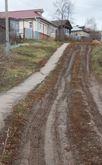 Fototapeta na wymiar footpath in the mountain province the rural mud of the slums. Russian reality