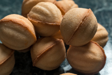 cookies walnut on green marble background close-up