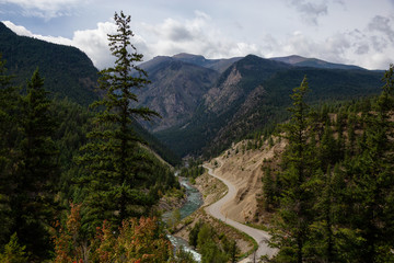 Fototapeta na wymiar Aerial View of a Scenic Dirt Road towards Gold Bridge in the Valley surrounded by Canadian Mountain Landscape. Taken near Lillooet, British Columbia, Canada.