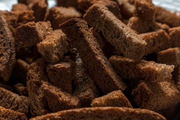 Rye crackers on green marble background close-up