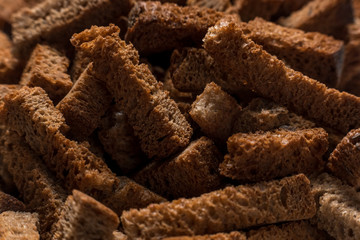 Rye crackers on green marble background close-up