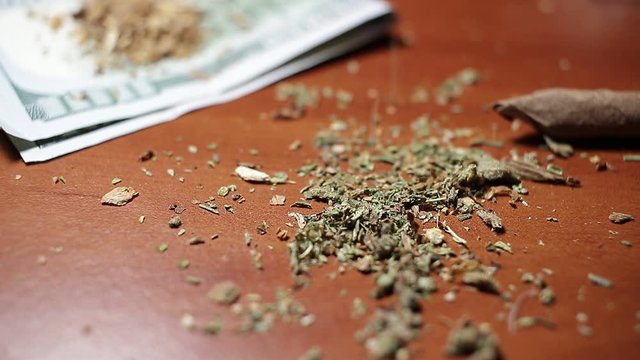 marijuana on the table, preparing to twist the jamb
