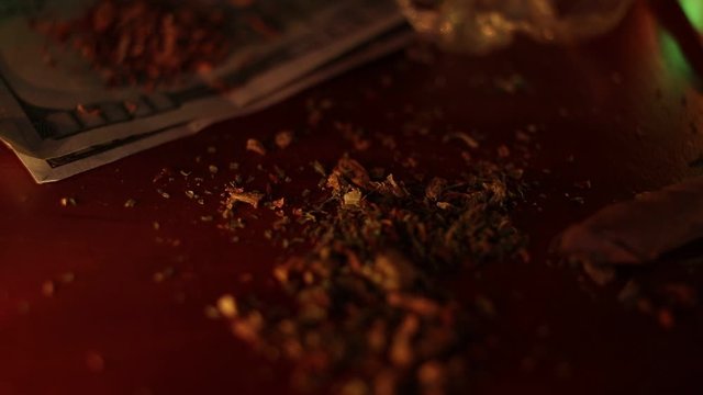 marijuana on the table, preparing to twist the jamb