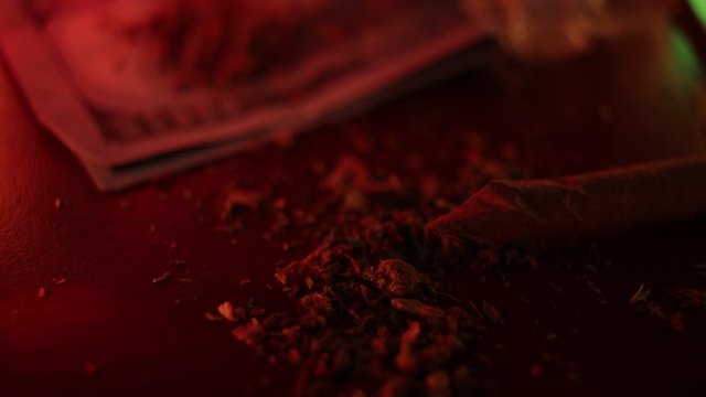 marijuana on the table, preparing to twist the jamb