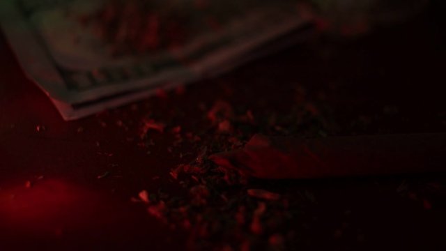 marijuana on the table, preparing to twist the jamb
