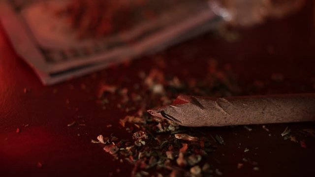 marijuana on the table, preparing to twist the jamb