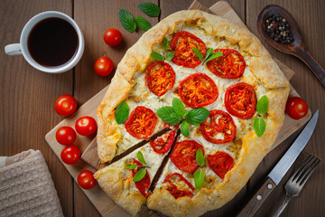 Homemade pizza with cheese and tomatoes.