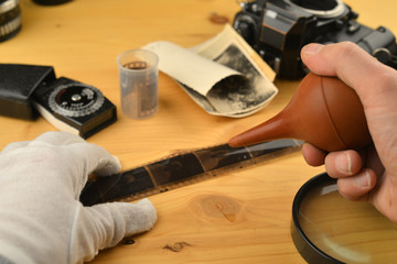 Analog photography concept dust removal on negative stripes