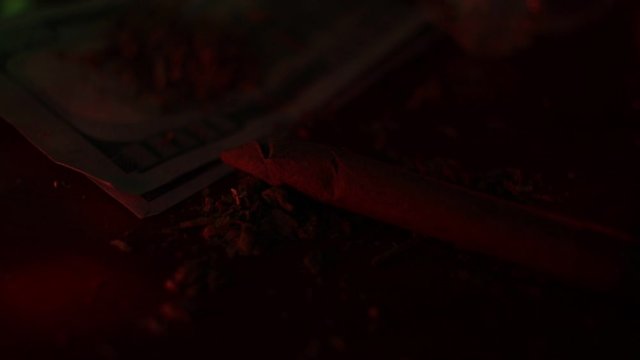marijuana on the table, preparing to twist the jamb