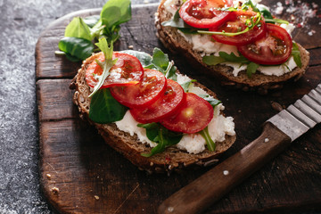 Whole grain bread bruschetta with cream cheese and cherry tomatoes