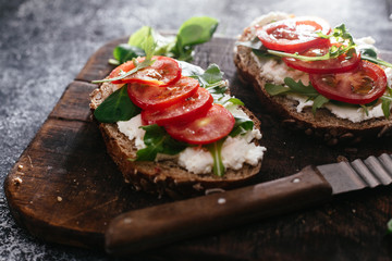 Whole grain bread bruschetta with cream cheese and cherry tomatoes