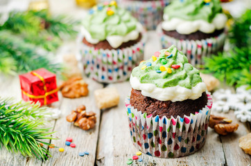 Chocolate cupcakes with green frosting and sprinkles on holiday