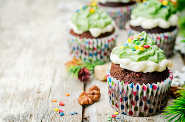 Chocolate cupcakes with green frosting and sprinkles on holiday