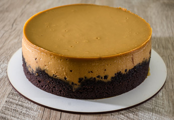 tasty cake with condensed milk on a wooden background.