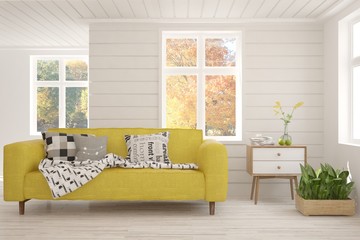 Stylish room in white color with sofa and autumn landscape in window. Scandinavian interior design. 3D illustration