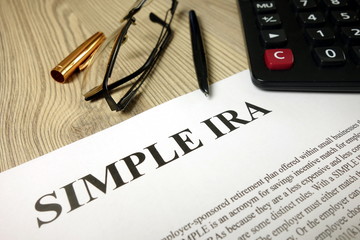 Simple ira document with pen calculator and glasses