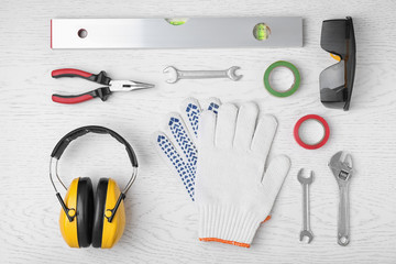 Flat lay composition with construction tools on white wooden background