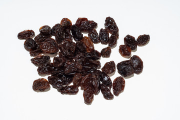 Raisins isolated on white background. Dried dark grapes. Diet healthy snack concept.